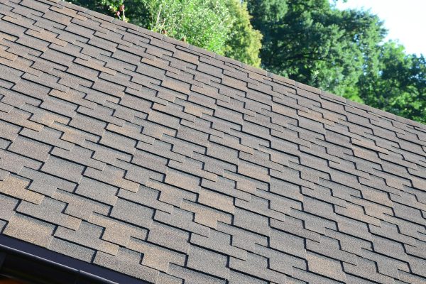 Modern roofing and decoration of chimneys. Flexible bitumen or slate shingles in rectangular shape in perspective.