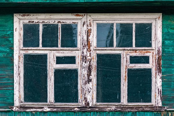 Windows of old shabby wooden house